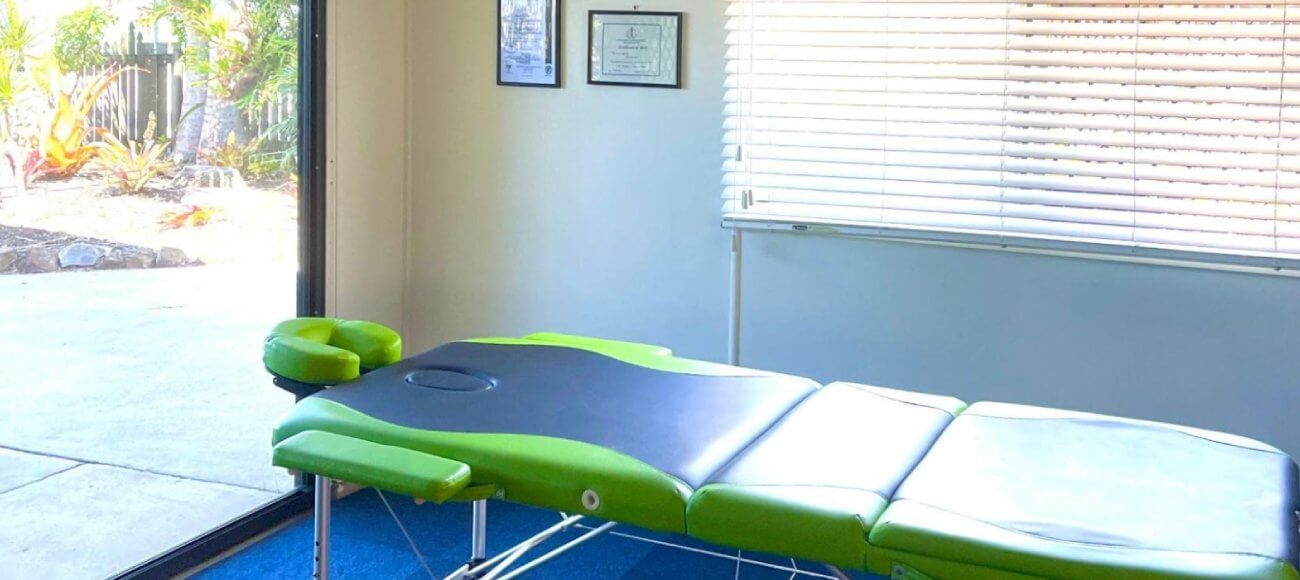 Modern adjustable medical hospital bed with green mattress at Forbode